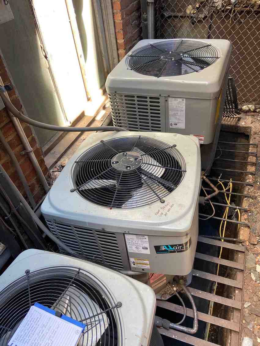 Professional HVAC technician installing and repairing a ductless mini split system in NYC.