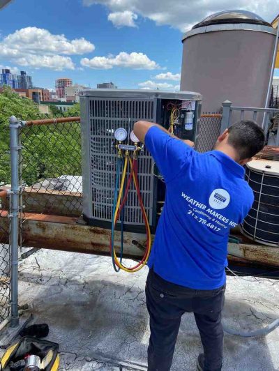 Technician servicing ducted central air conditioning system