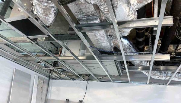 Technician installing ducted central air conditioning system in New York City